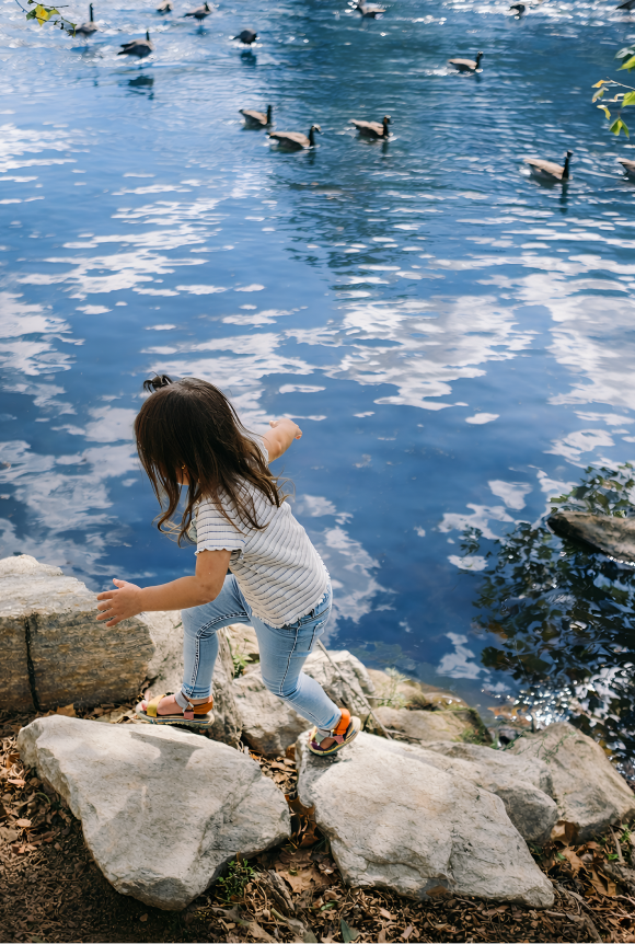 Girl Playing by the water